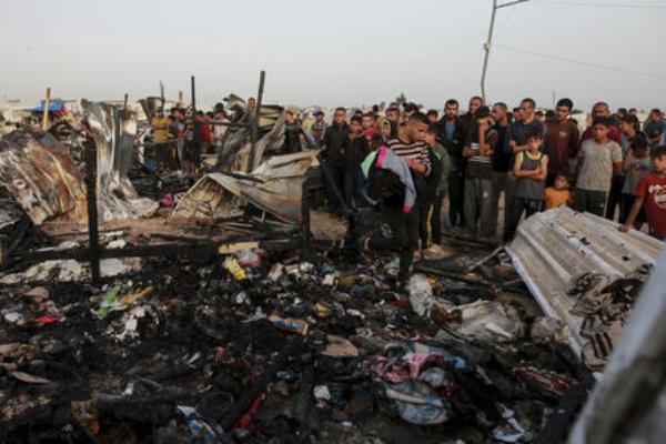 Palestinians look at the destruction after an Israeli strike where displaced people were staying in Rafah, Gaza Strip, Monday, May 27, 2024. Palestinians look at the destruction after an Israeli strike where displaced people were staying in Rafah, Gaza Strip, Monday, May 27, 2024.